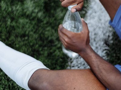 Close up of sports shoes and water bottle.
